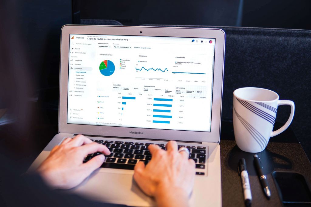 Notebook com gráficos de métricas para e-commerce sendo mostrados na tela.